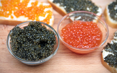 Black and red caviar in glass container