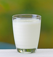 Glass of milk placed on a wooden background nature.