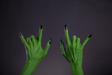 Green monster hands showing heavy metal gesture © Elisanth