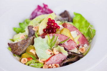food, salad with iceberg, meat, mushrooms, pickles and hazelnuts