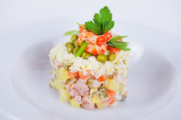 classic salad decorated with shrimp and parsley to the menu on a