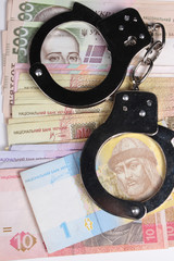 Criminal. Handcuffs and money. Corruption
