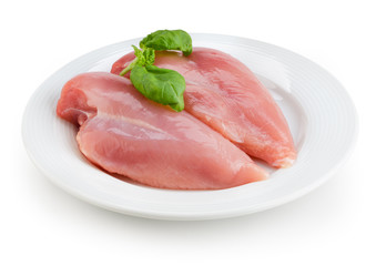 Raw chicken fillets on white plate isolated. With clipping path.