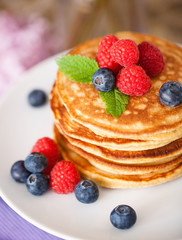 Stack of pancakes with fresh berries