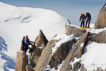 Alpine climbers climbing on a rock in the Mont Blanc massif