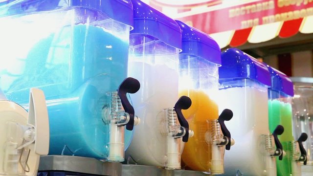 Moist juice machines in action. Machine for making ice slushy drinks 