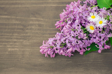 Colorful lilac  flowers on wooden background