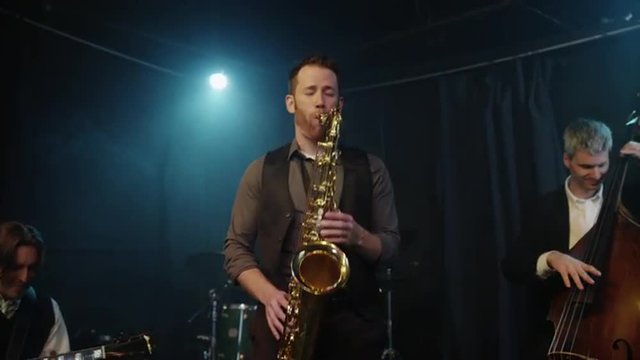 Panning shot of musicians playing musical instruments / Provo, Utah, United States, 