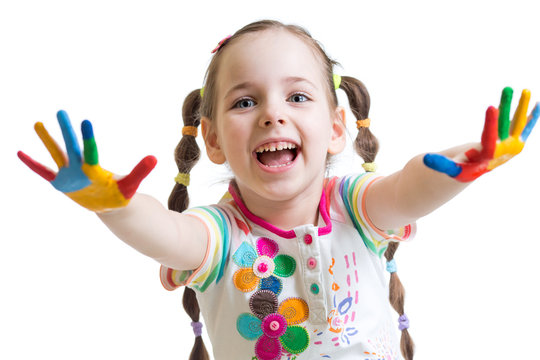 smiling child girl with colorful hands in paints on white