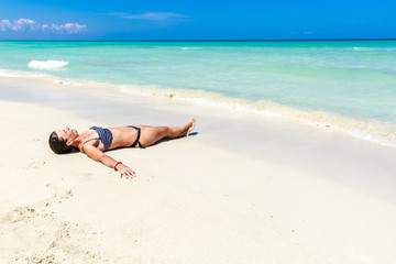 Girl lying on caribbean beach