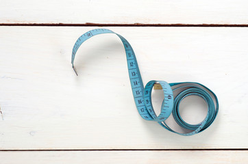 twisted tape measure on white background