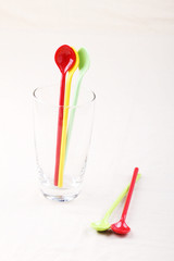 colorful plastic spoon in clear glass