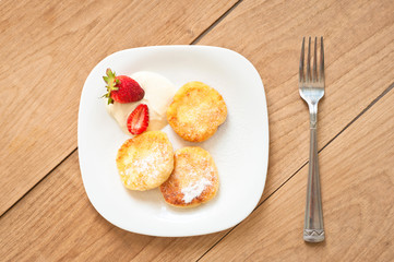 Breakfast of tasty round pancakes with cottage cheese with fragr