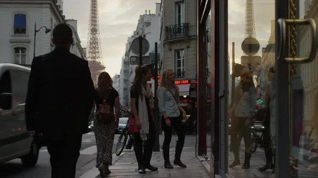 Close Up Of Friends Window Shopping On City Street / Paris, France