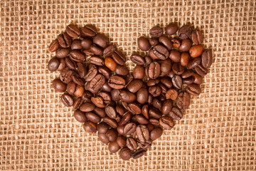 heart of coffee beans on sackcloth