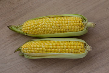 Corn cobs on wood background