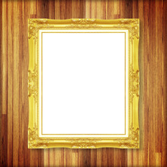 Antique gold frame on wooden wall ;. Empty picture frame on whit