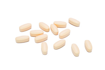 Heap of orange round medicine tablet pills