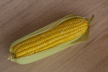 Corn cobs on wood background