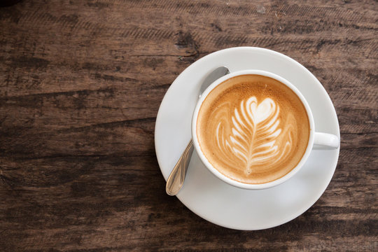 Cup Of Heart Latte Art On Wood Table. 