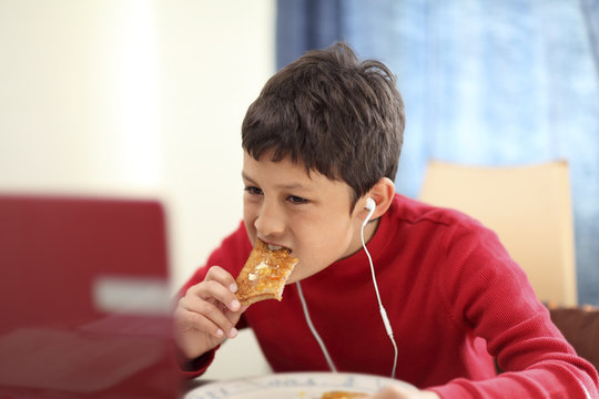 Young Boy Eating Breakfast Toast