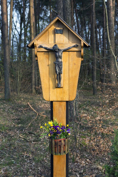 crucifix in front of trees