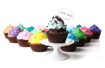 Delicious cupcakes with inscription isolated on white