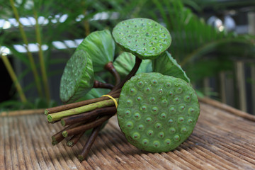 Lotus pods on rattan table © yarlander