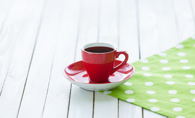 Cup of coffee or tea on polka dot napkin