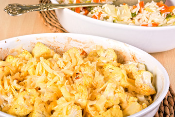 Cauliflower baked in a white casserole sprinkled with cheese. Ca