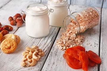Healthy breakfast with dried fruits and nuts on color wooden background