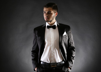 Elegant man in suit on dark background