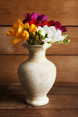 Beautiful spring flowers on wooden background