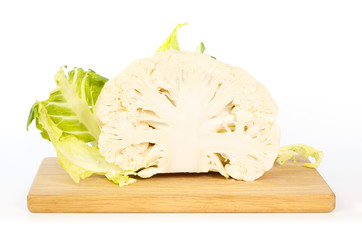 Half a cauliflower on wooden cutting board