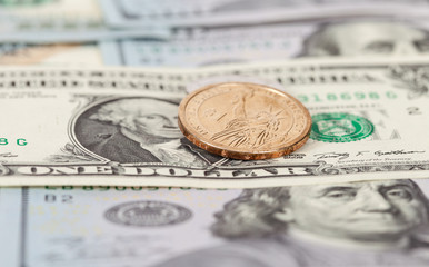 One American dollar coin over banknotes close up