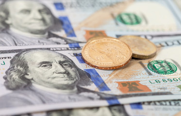 American dollar coins over banknotes close up