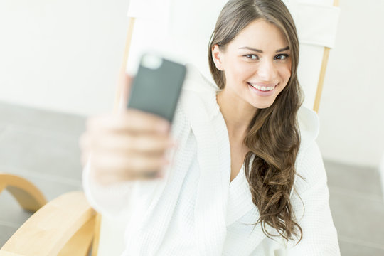 Young woman taking selfie with mobile phone