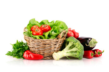 Full basket of ripe vegetables on white background