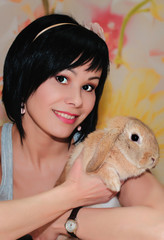 portrait of a girl with a little dwarf rabbits