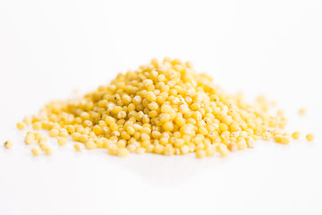 Heap of millet groats on white