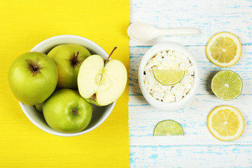 Apples, cottage cheese and lemons on wooden table top view
