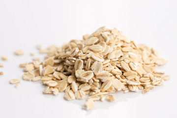Oat flakes pile on white background