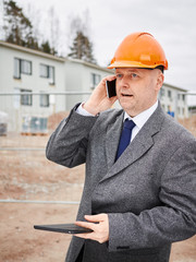 Engineer and house construction site