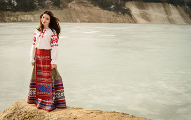young woman in Slavic Belarusian national original suit outdoors