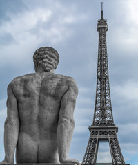 Fototapeta na wymiar Stone statue over Eiffel tower on background