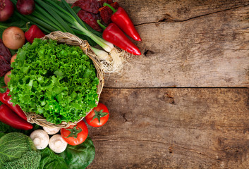 Fresh ripe vegetables on wooden table background