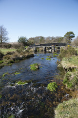 Ancient Clapper bridge at Postbrige on Dartmoor Devon UK