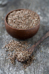 dried cumin on wooden surface