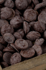 Fototapeta na wymiar dark chocolate chips in woden box