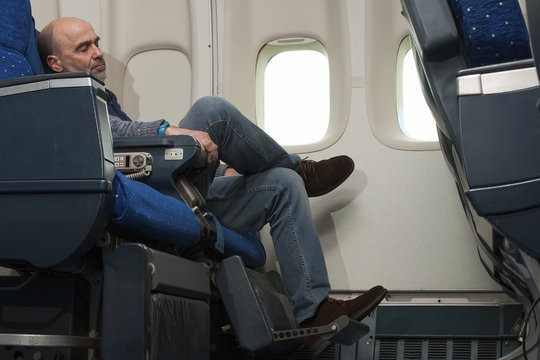 commercial airline passenger sitting inside the plane